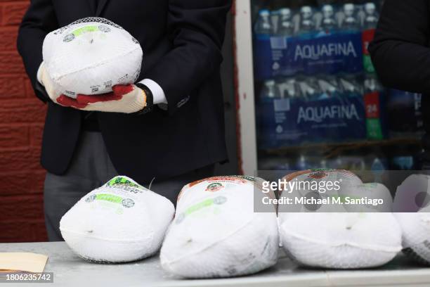 Frozen turkeys are seen on a table during a giveaway at Green Valley of Sunnyside Market Place on November 21, 2023 in the Sunnyside neighborhood of...