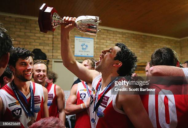 Healesville players drink from the trophy as they celebrate in the changing rooms after winning the Yarra Valley Mountain District Football League...