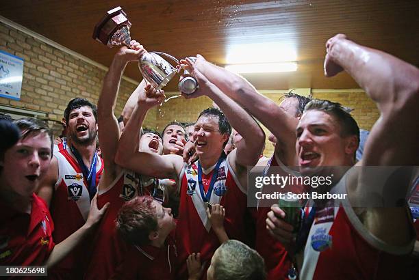 Healesville players celebrate with the trophy in the changing rooms after winning the Yarra Valley Mountain District Football League Division 2...