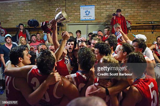 Healesville players celebrate with the trophy in the changing rooms after winning the Yarra Valley Mountain District Football League Division 2...