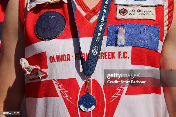 An Olinda Ferny Creek player with his premiership medal around his kneck after winning the Yarra Valley Mountain District Football League Under 18...