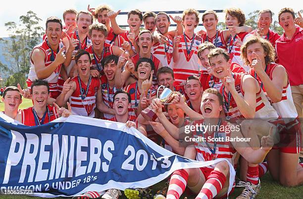 Olinda Ferny Creek players celebrate after being presented with the premiership flag and trophy after winning the Yarra Valley Mountain District...