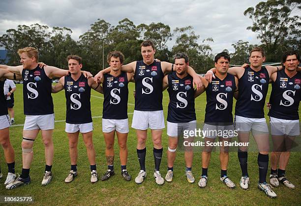 Seville players stand for the Australian national anthem before the start of the the Yarra Valley Mountain District Football League Division 2...