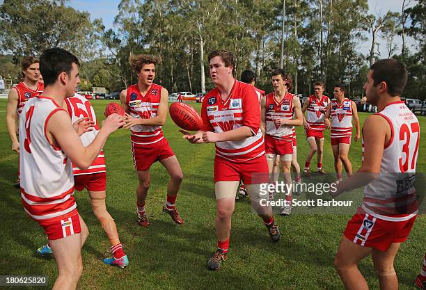 Olinda Ferny Creek players perform a training drill before the start of the Yarra Valley Mountain District Football League Under 18 Grand Final...