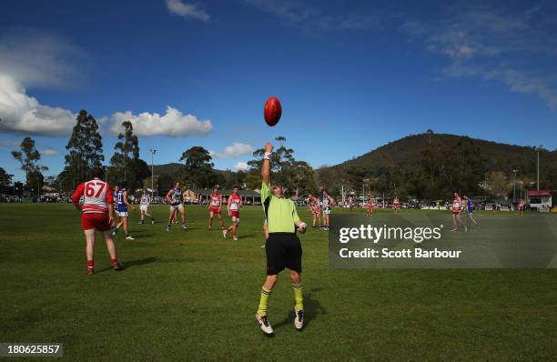 An umpire throws the ball into play during the Yarra Valley Mountain District Football League Under 18 Grand Final between Olinda Ferny Creek and...