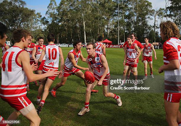 Olinda Ferny Creek players perform a training drill before the start of the Yarra Valley Mountain District Football League Under 18 Grand Final...