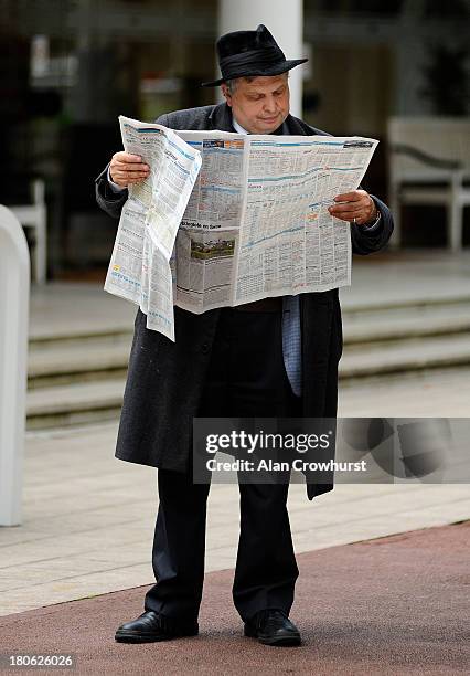 Man studies the form at Longchamp racecourse on September 15, 2013 in Paris, France.