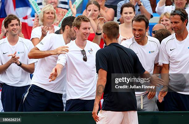 Daniel Evans of Great Britain is congratulated by Jonny Marray and Ross Hutchins after he defeated Mate Pavic of Croatia during day three of the...