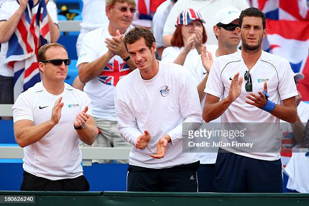 Daniel Evans of Great Britain is supported by Matt Little, Andy Murray and James Ward of Great Britain in his match against Mate Pavic of Croatia...
