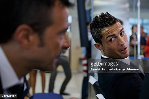 Crsitiano Ronaldo speaks with his agent Jorge Mendes after his signing contract renewal For Real Madrid at Estadio Santiago Bernabeu on September 15,...