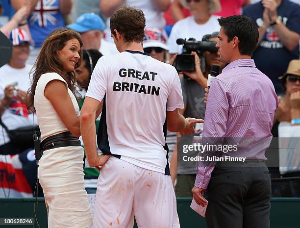 Andy Murray of Great Britain talks to Eurosport's Annabel Croft and Jamie Baker after his win over Ivan Dodig of Croatia during day three of the...