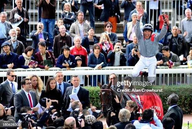 Frankie Dettori riding Treve celebrate winning The Qatar Prix Vermeille at Longchamp racecourse on September 15, 2013 in Paris, France.