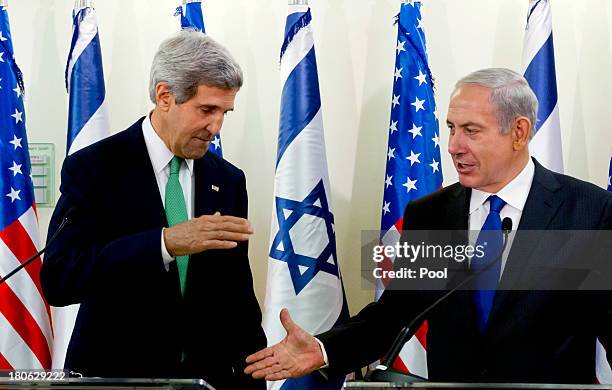 United States Secretary of State John Kerry and Israeli Prime Minister Benjamin Netanyahu go to shake hands at the conclusion of their statements...