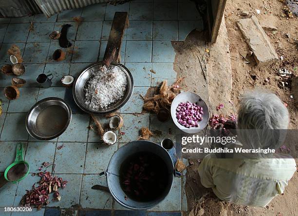 Sri Lankan ethnic Tamil man prepares temple food at Hindu temple, fomer rebel capital of Kilinochchi, on September 15, 2013 in Kilinochchi, Sri...