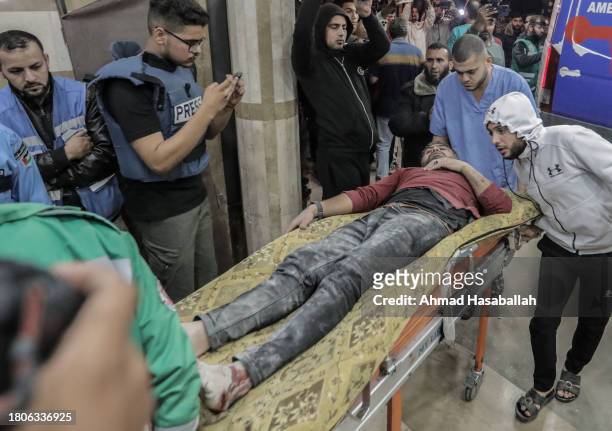 Palestinians injured in Israeli raids arrive at Nasser Medical Hospital on November 21, 2023 in Khan Yunis, Gaza. More Gaza residents have fled south...