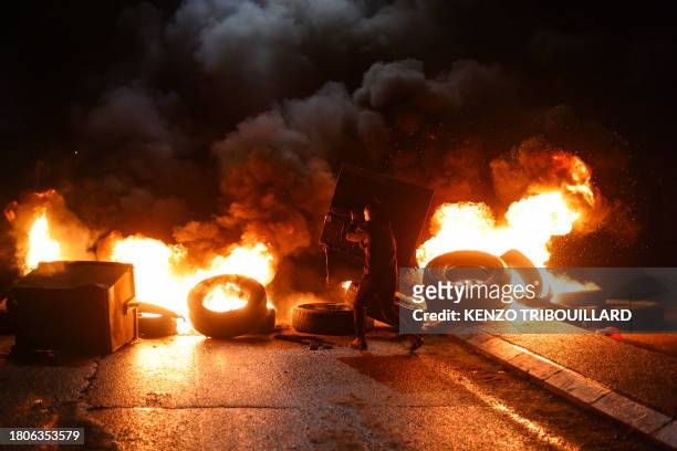 Protester burns tyres in Ramallah in the occupied West Bank on November 27 ahead of an expected release of Palestinian prisoners in exchange for...