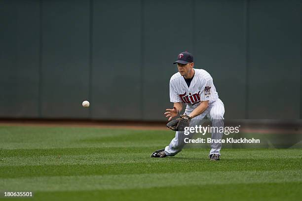 Clete Thomas of the Minnesota Twins fields a ball hit by the Toronto Blue Jays on September 8, 2013 at Target Field in Minneapolis, Minnesota. The...