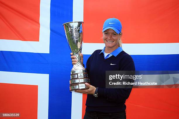 Suzann Pettersen of Norway holds the trophy after securing victory in the third round of The Evian Championship at the Evian Resort Golf Club on...