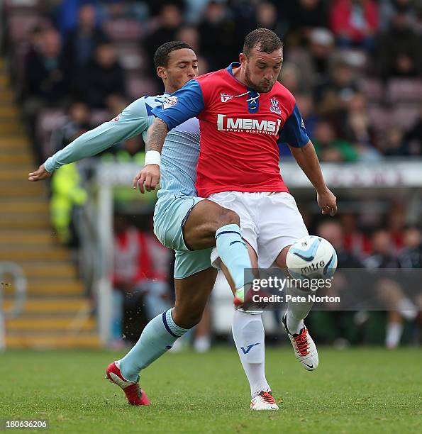 Danny Kedwell of Gillingham attempts to control the ball under pressure from Jordan Clarke of Coventry City during the Sky Bet League One match...