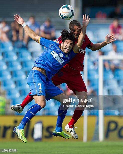 Angel Lafita of Getafe battles for the ball against Paxi Punal of Osasuna during the La Liga match between Getafe CF v CA Osasuna at Coliseum Alfonso...