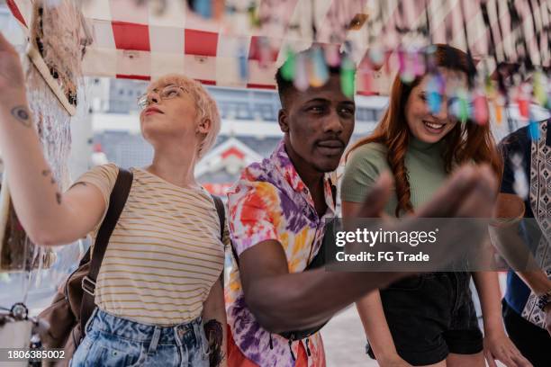 friends buying souvenirs at street market - market square stock pictures, royalty-free photos & images