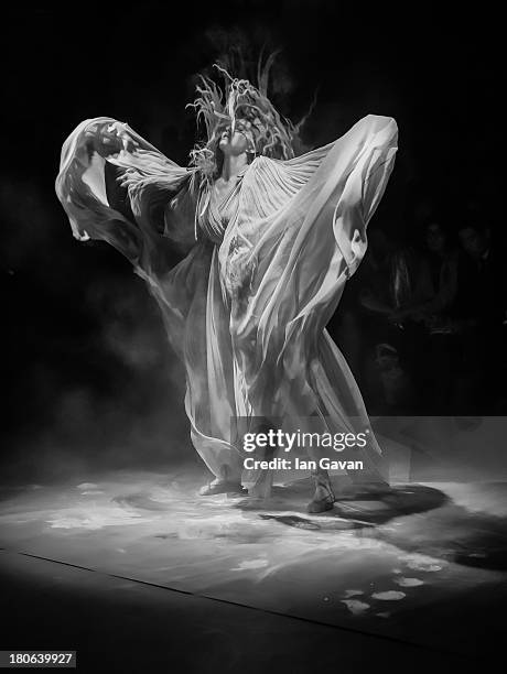 Model Lily Cole dances on stage during the Vivienne Westwood Red Label show during London Fashion Week SS14 at the German Gymnasium on September 15,...