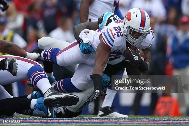 Fred Jackson of the Buffalo Bills is tackled during NFL game action by Mario Addison of the Carolina Panthers at Ralph Wilson Stadium on September...