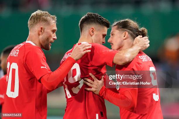 Marcel Sabitzer of Austria celebrates with teammates Konrad Laimer and Christoph Baumgartner after scoring the team's first goal during the...