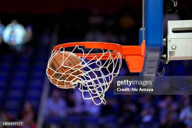 Wilson Brand NBA official game ball is pictured falling through a basketball hoop and net before the game between the Detroit Pistons and Denver...