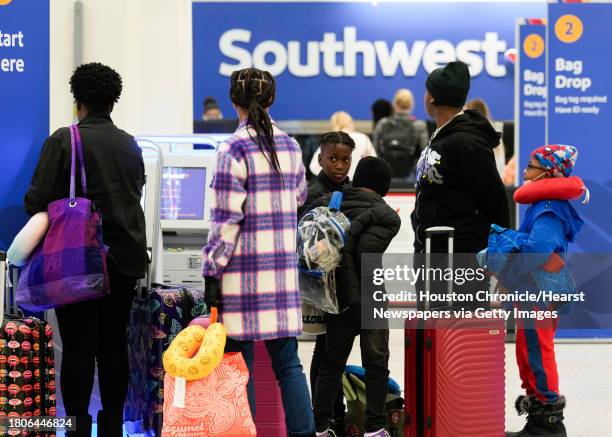 Travelers check in at Southwest Airlines at George Bush Intercontinental Airport, Tuesday, Nov. 21 in Houston.