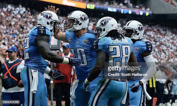 Jake Locker of the Tennessee Titans celebrates with Delanie Walker after a touchdown in the second half against the Houston Texans at Reliant Stadium...