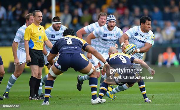 Ofisa Treviranus of Irish passes the ball as Paul Hodgson of Warriors dives in during the Aviva Premiership match between Worcester Warriors and...