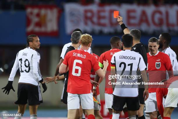 Referee Slavko Vincic shows a red card to Leroy Sane of Germany during the international friendly match between Austria and Germany at Ernst Happel...