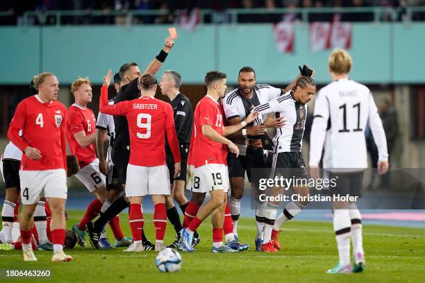Referee Slavko Vincic shows a red card to Leroy Sane of Germany during the international friendly match between Austria and Germany at Ernst Happel...