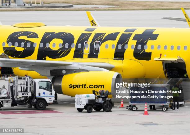 Ground crews work to prepare a Spirit Airlines plane at George Bush Intercontinental Airport, Tuesday, Nov. 21 in Houston.