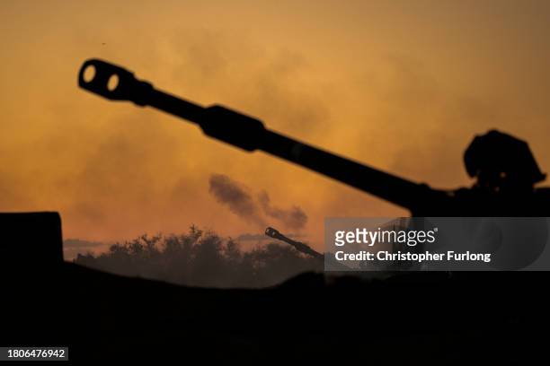 Israeli artillery train their guns towards the Gaza strip on November 21, 2023 in Southern Israel. More than a month after Hamas's Oct. 7 attacks,...