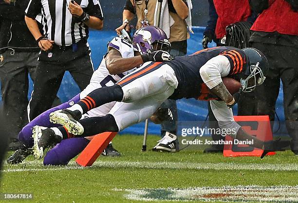 Martellus Bennett of the Chicago Bears scores the game-winning touchdown over Chris Cook of the Minnesota Vikings with 10 seconds left in the game at...
