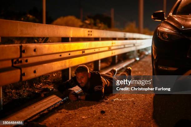 People try to take shelter on a highway during a rocket alert on November 21, 2023 in Southern Israel. More than a month after Hamas's Oct. 7...