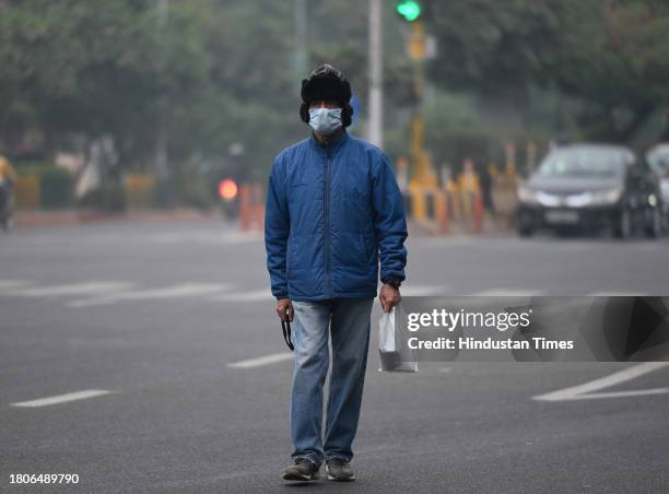 With worsening AQI in Delhi NCR, some residents have started wearing masks to protect themselves from pollution and smog in afternoon, on November...