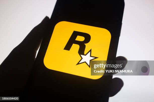 This illustration shows a logo of Rockstar Games on a smartphone screen in New York in New York, November 27, 2023. Rockstar Games, the studio behind...