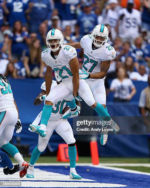 Brent Grimes of the Miami Dolphins celebrates with Jimmy Wilson after intercepting a pass in the 4th quater during the Dolphins 24-20 win over the...