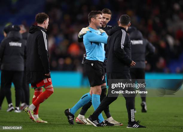 Danny Ward of Wales speaks to referee Matej Jug after the UEFA EURO 2024 European qualifier match between Wales and Turkey at Cardiff City Stadium on...