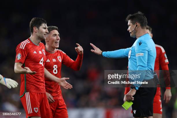 Ben Davies and Harry Wilson of Wales complains to referee Matej Jug after he gives a penalty to Turkey during the UEFA EURO 2024 European qualifier...