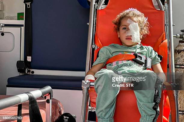 Egyptian paramedics transfer an injured Palestinian arriving on the Egyptian side of the Rafah border crossing with the Gaza Strip on November 27,...