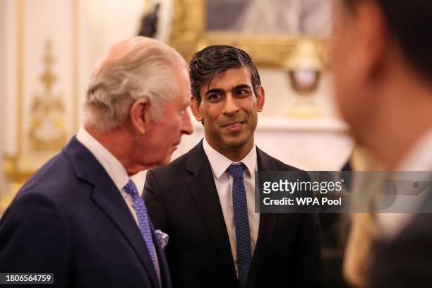 Britain's Prime Minister Rishi Sunak reacts as he attends a reception hosted by Britain's King Charles III to mark the conclusion of the Global...