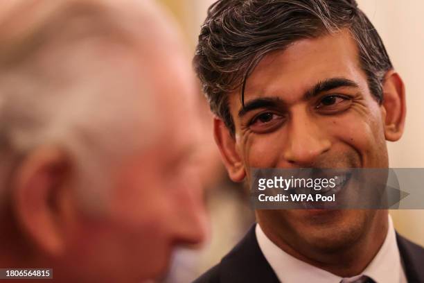 Britain's Prime Minister Rishi Sunak reacts as he attends a reception hosted by Britain's King Charles III to mark the conclusion of the Global...