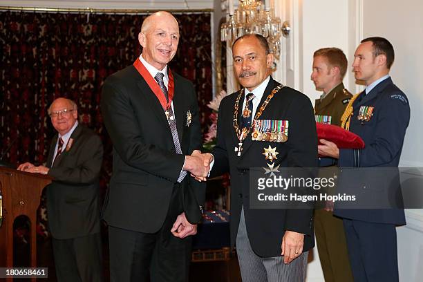 Sir Gordon Tietjens receives a knighthood and the Insignia of a Knight Companion of the New Zealand Order of Merit from Governor-General Sir Jerry...