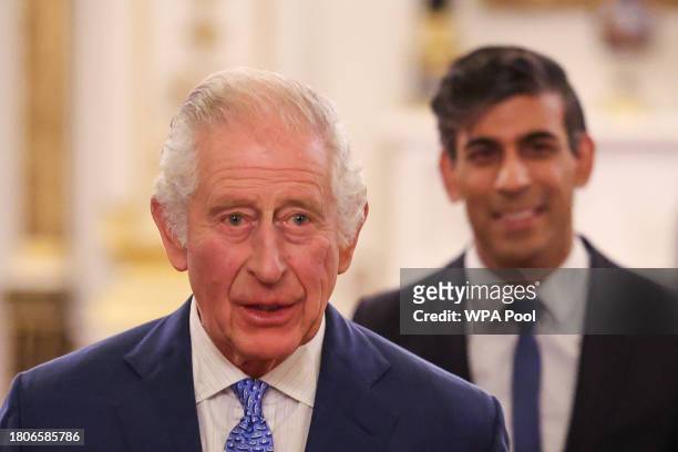 Britain's King Charles III followed by Britain's Prime Minister Rishi Sunak arrives to host a reception to mark the conclusion of the Global...