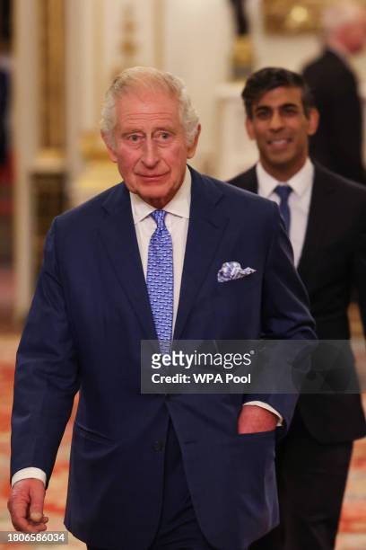 Britain's King Charles III followed by Britain's Prime Minister Rishi Sunak arrives to host a reception to mark the conclusion of the Global...