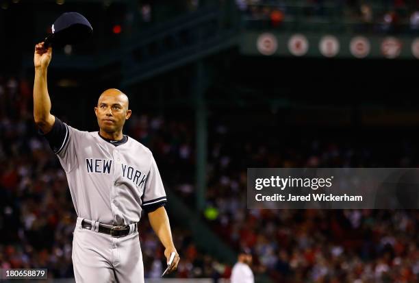 Mariano Rivera of the New York Yankees tips his hat to the crowd after being honored prior to the game against the Boston Red Sox on September 15,...